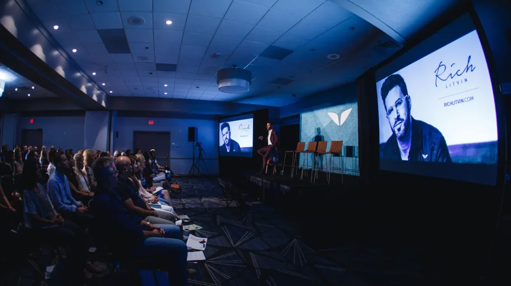 Transformational coach Rich Litvin on stage at a Mindvalley event in 2017