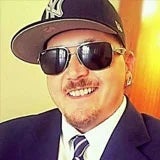 Tony-Doyle a man wearing a hat and sunglasses