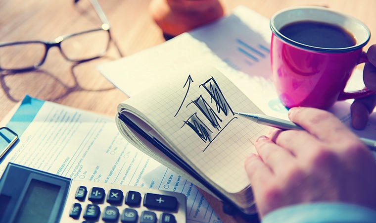 a person writing on a piece of paper