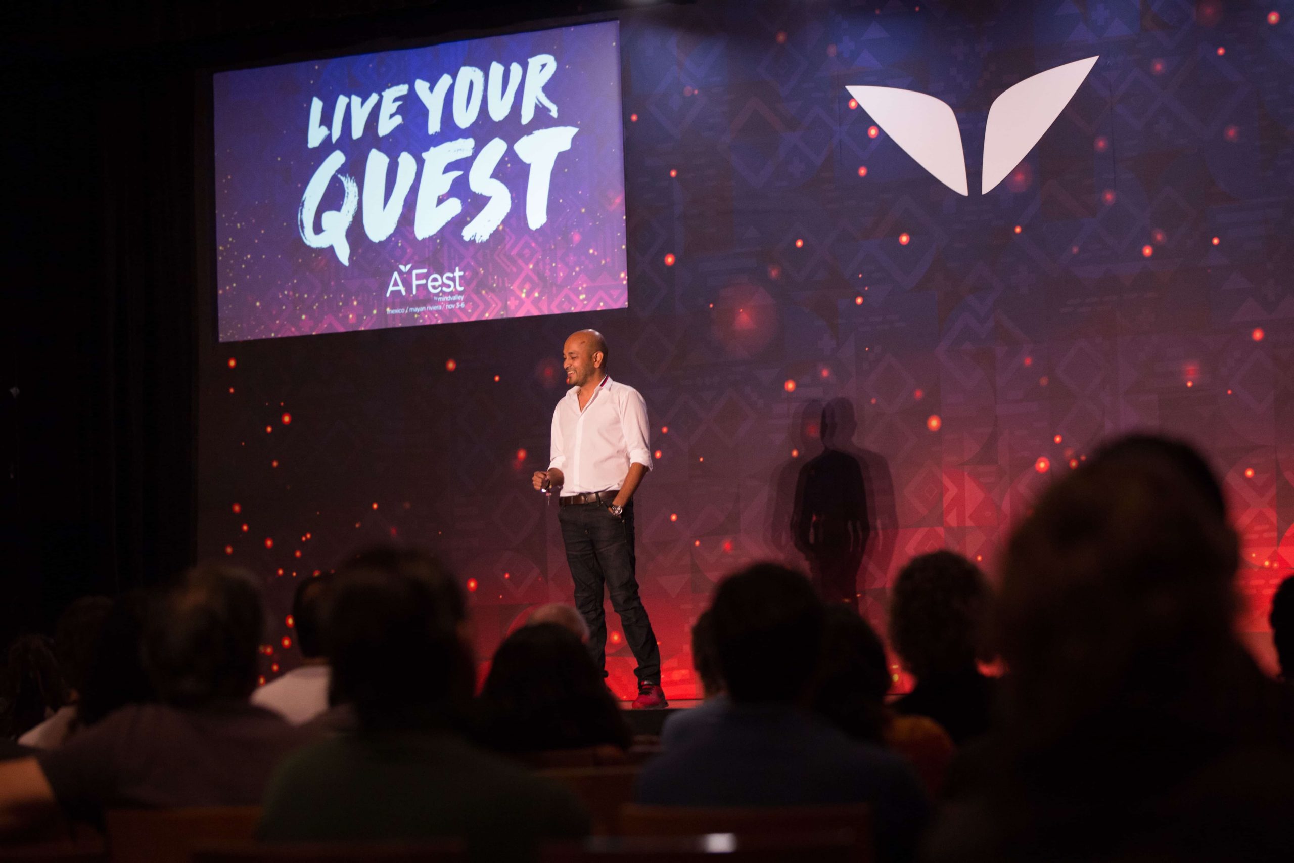 Ajit Giving a Speech in front of 300 people at A-Fest Mexico 2016-min a person standing on a stage with a crowd watching
