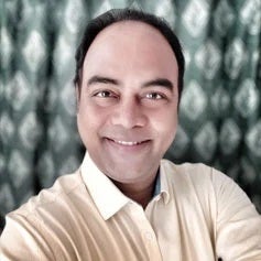 Ranjan-Kumar-min a man smiling for the camera