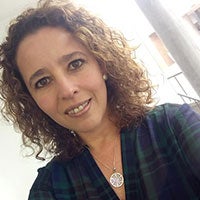 Testi Juanita-Andrade a woman smiling for the camera