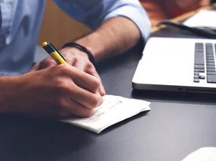 Being an Exponential Coach a person writing on a piece of paper