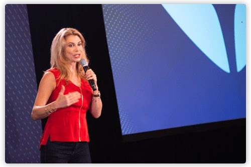 Christine Hassler holding a microphone