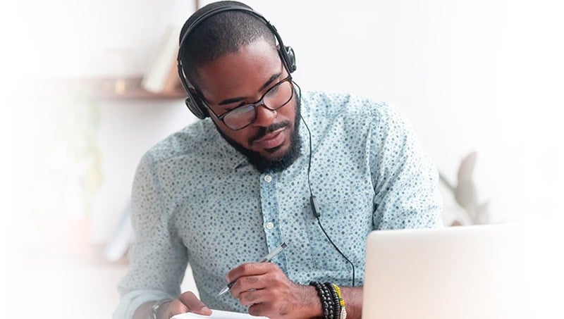 bonus-19-responsive-min a man wearing headphones and holding a pen