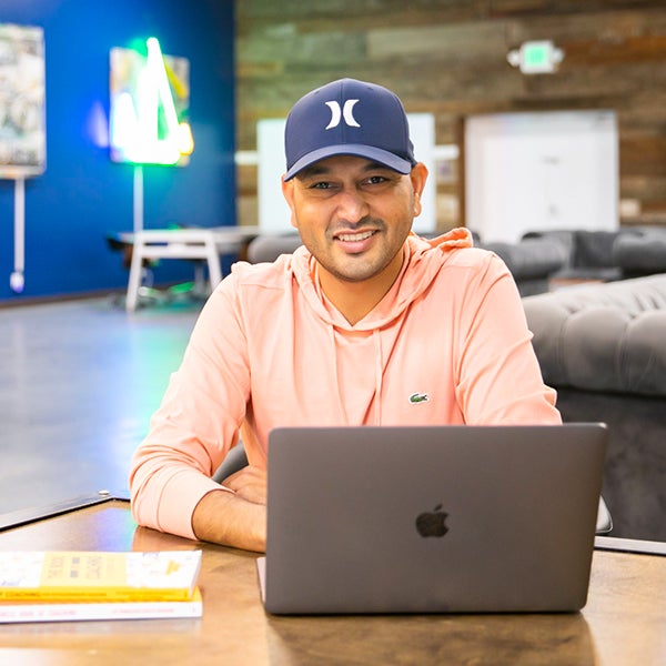 a woman sitting at a table with a laptop
