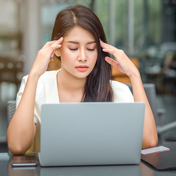 Woman-Doubting-with-laptop a woman with her hands on her head looking at a laptop