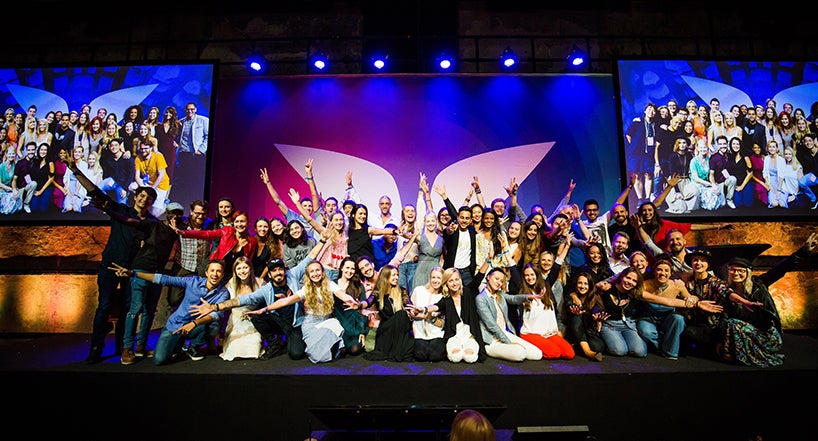 a group of people posing for a photo on a stage